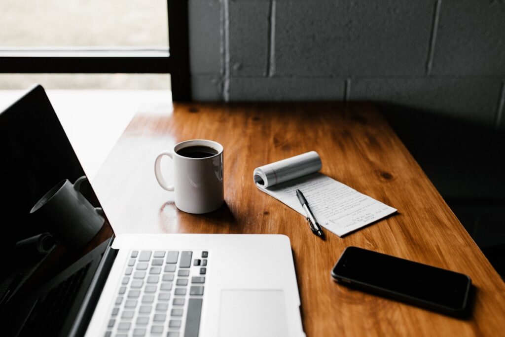 Notebook and pen beside coffee - Quiger daily sudoku